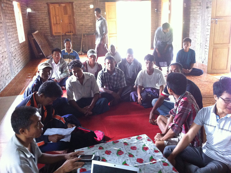 The Clinic and village leaders are waiting for the villagers to arrive at the meeting site. One of them in the photo is a plain clothes officer with a recording device, as pointed out by one of the villagers.
