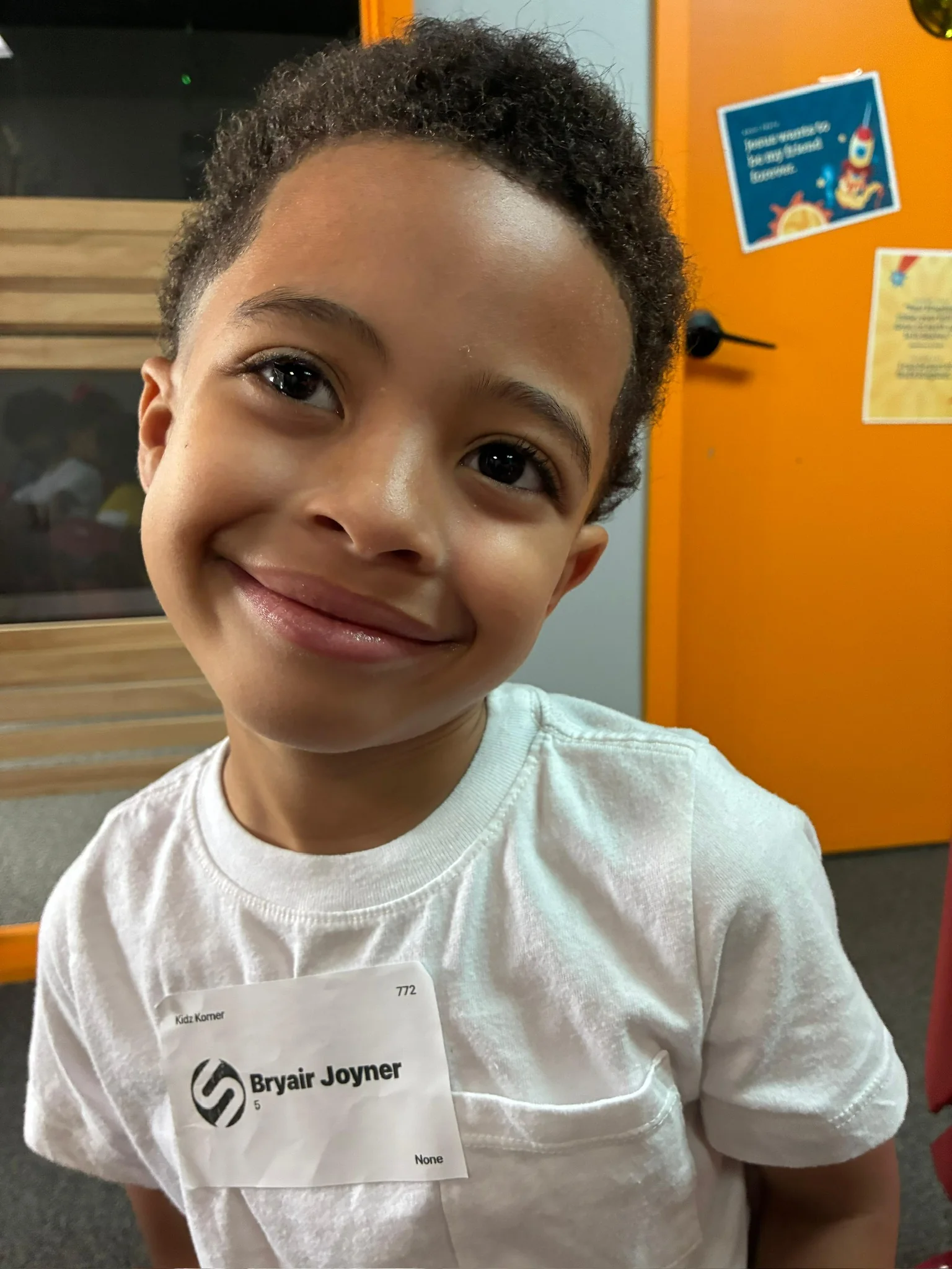 A smiling child in Kidz Korner