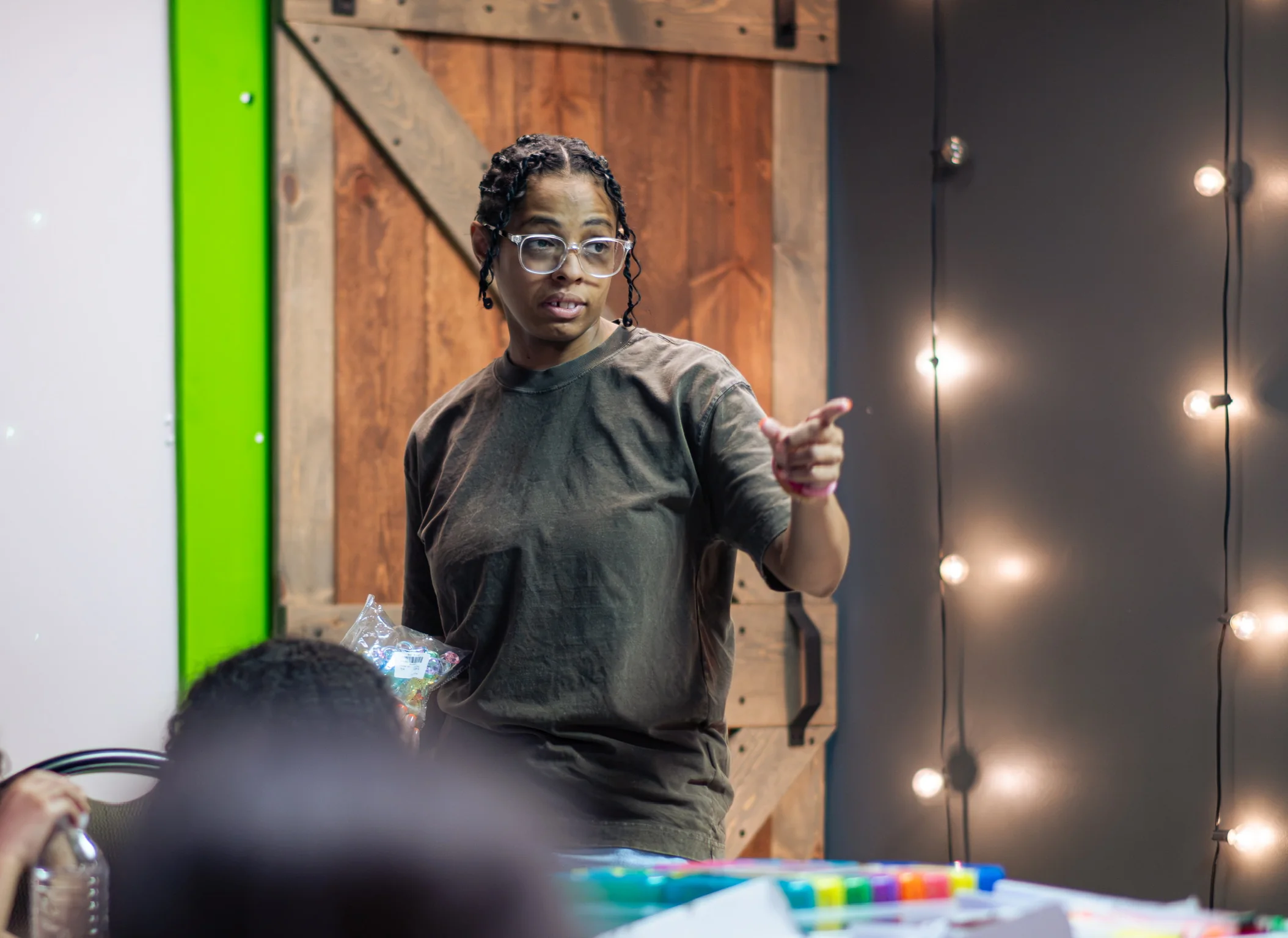 An adult Kidz Korner leader teaching children in the classroom