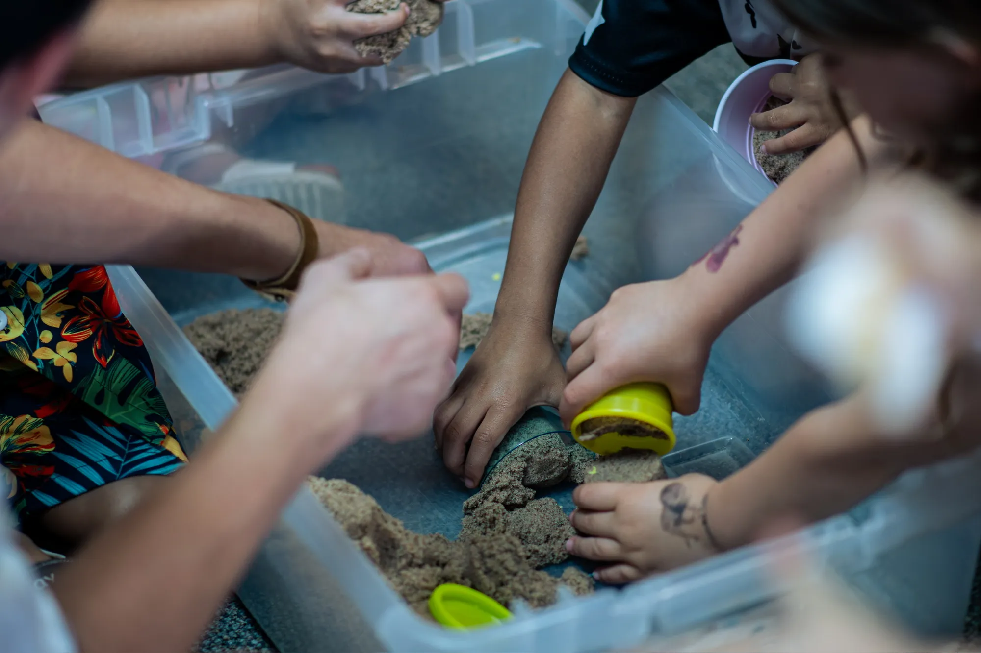 Children and a helper participating in a sensory activity
