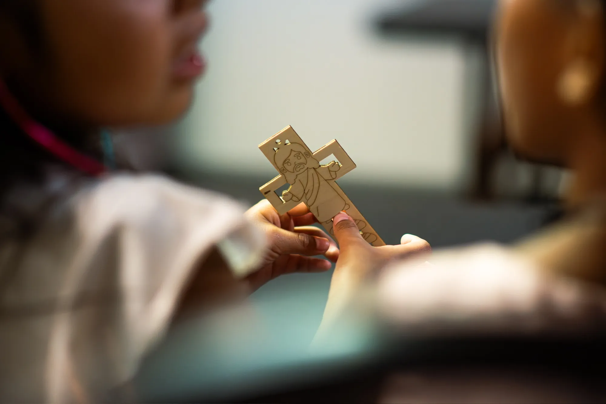 Children holding a handmade cross craft