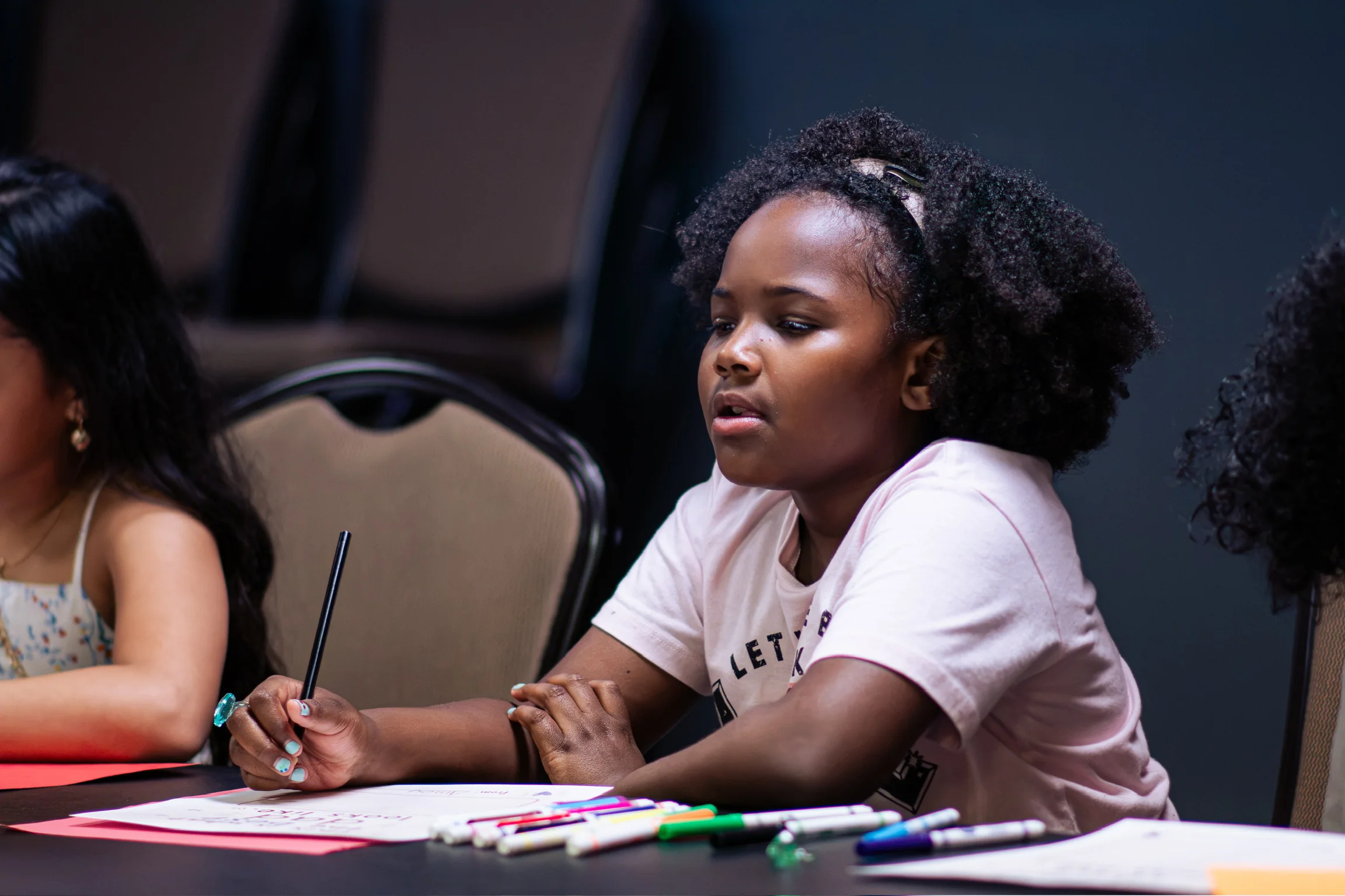 A child engaged in a Kidz Korner table activity