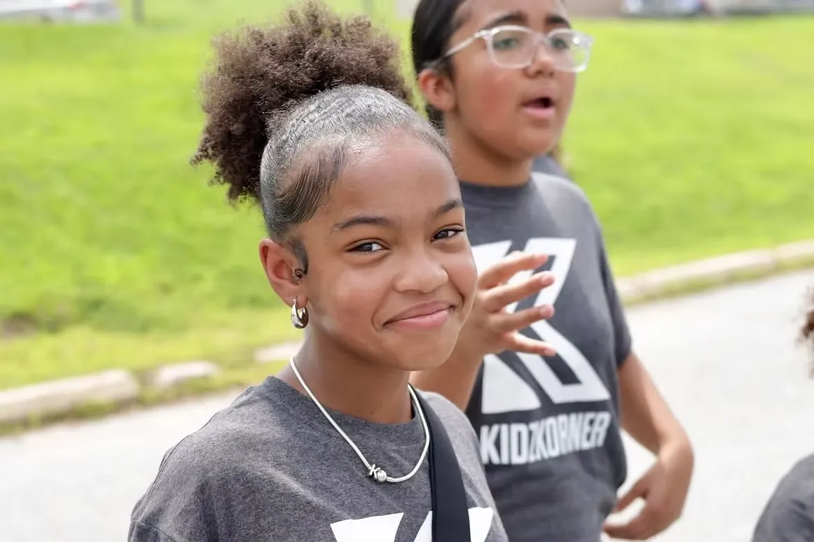 A Kidz Korner volunteer helping a child