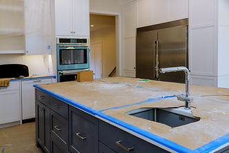 Renovation work is in progress in modern kitchen featuring exposed unfinished countertops