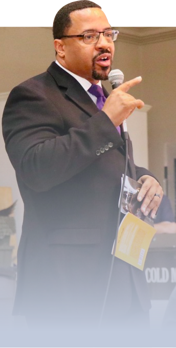 Honorable Torrance Harvey Sr. standig ih a mic in his hand