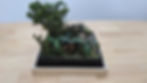 Scale model diorama of a jungle scene with dinosaurs.