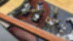 Dinosaur figurine on a miniature control room desk