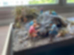 Diorama of people tending to a sick Triceratops