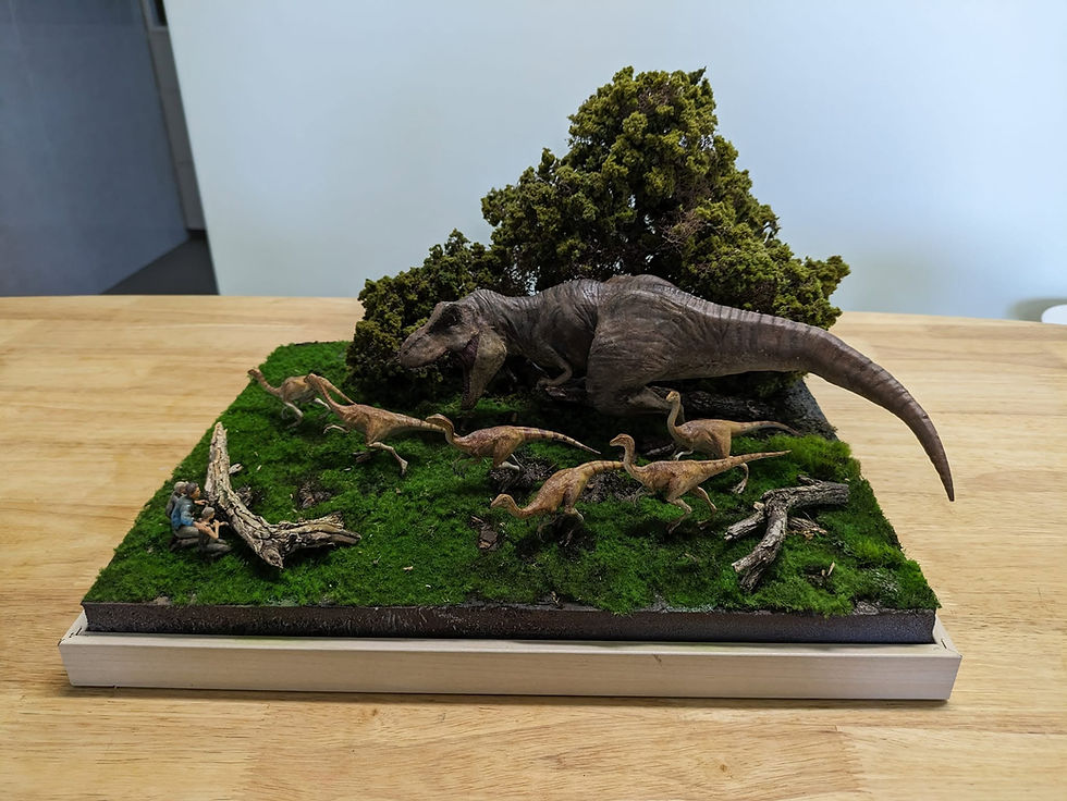 Diorama of a T-Rex emerging from bushes to ambush Gallimimus.