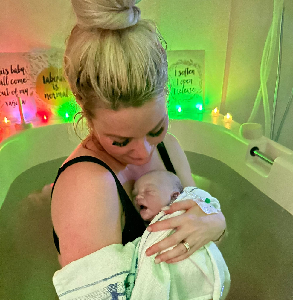 woman with newborn baby in hospital birthing pool