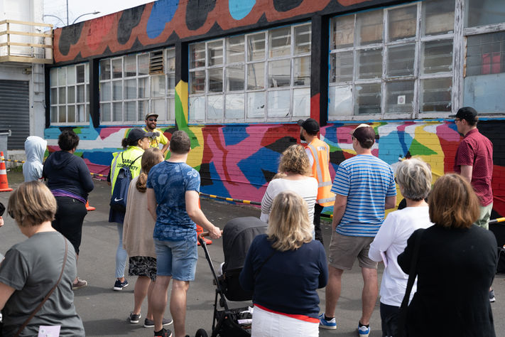 Street art tour by Street Artearoa stopping by artist Sean Anoma's mural. 