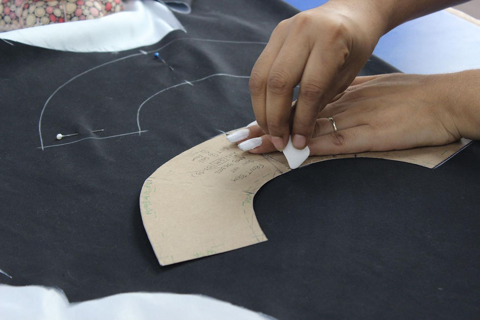 Hands working on a garment pattern