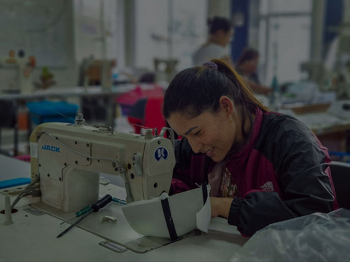 Women sewing a cap at Purnaa