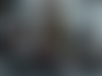 Three people sit on a couch looking somber near a decorated Christmas tree. Two others chat in the background. Text: "Clinical reasons people feel worse during the holidays."