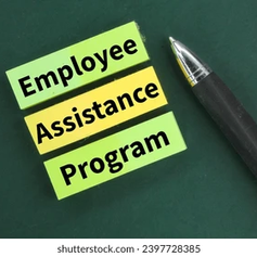 Sticky notes reading Employee Assistance Program beside a black pen on a green background.