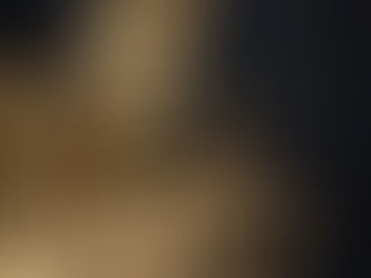 Gold blister packs and pills scattered on a black background, illustrating the side effects of Tirzepatide vs Semaglutide