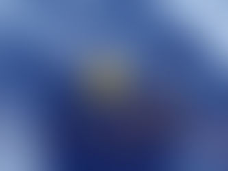 Cracked heart-shaped object glowing with yellow light on a textured blue surface, conveying suppressed emotions.