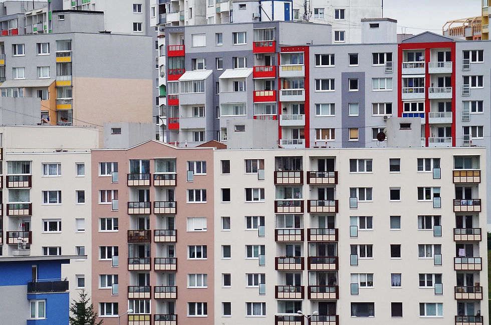 Urban apartment buildings with colorful balconies and varied facades fill the frame. The mood is neutral, with no visible text.