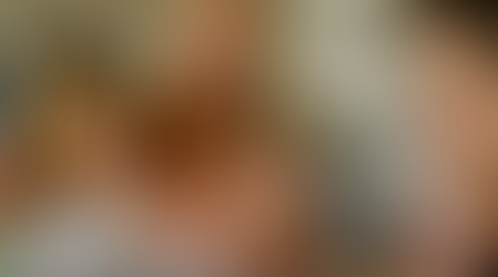 Family cooking together in a kitchen. Two kids and parents crack eggs into a bowl. Warm lighting, white and beige decor, cheerful mood.