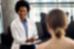 happy african american doctor talking with female-patient -during-psychotherapy-session.jpg