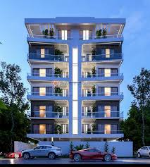 Modern six-story apartment building at dusk, illuminated with warm lights.; Ambience Apartments