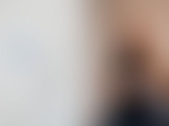 Smiling woman with red hair in black top stands near a whiteboard with diagrams. Suggesting high-functioning depression