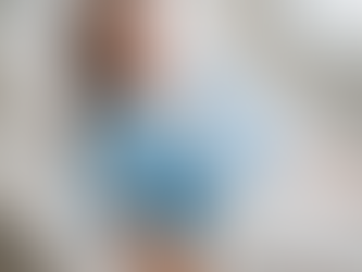 Woman in a hospital bed wearing a blue gown, looks calm. Medical equipment in the background. Illustrating the role of Medication Management vs. Therapy