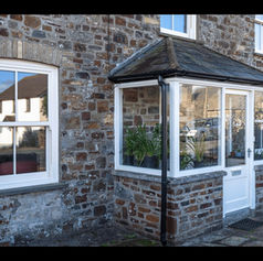 old brick house with white panel windows