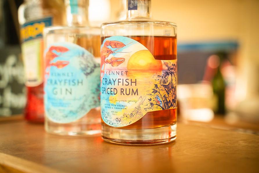 Close-up of colorful bottled beverages displayed on a bar counter with a blurred background.