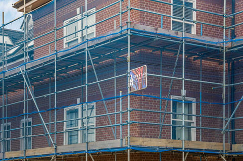 large red brick building with scaffolding