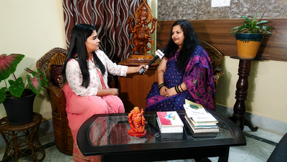 Reporter interviewing a woman in a living room