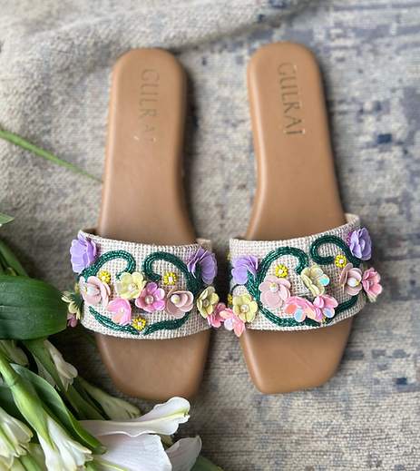 Handcrafted pastel slides with botanical beaded detailing and a comfortable flat sole.
