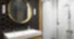 A modern bathroom with black and gold honeycomb wall tiles, white hexagon shower tiles, a circular mirror, and a vanity.