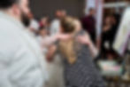 Bride hugging live wedding painter and smiling