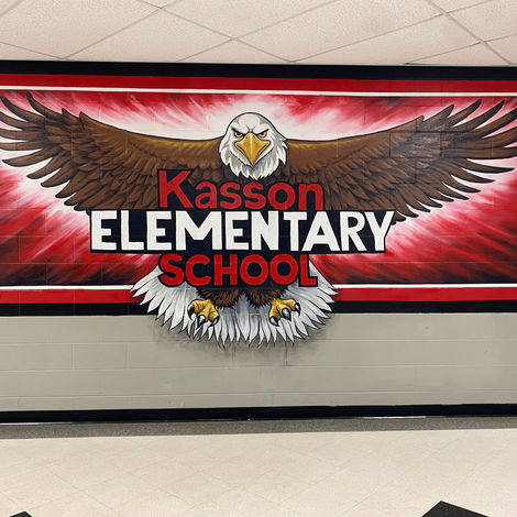 20'x 5' mural of an eagle surrounded by red and black colors on cinderblock wall
