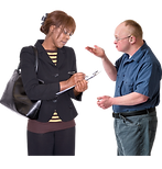 A woman taking notes while a man talks.