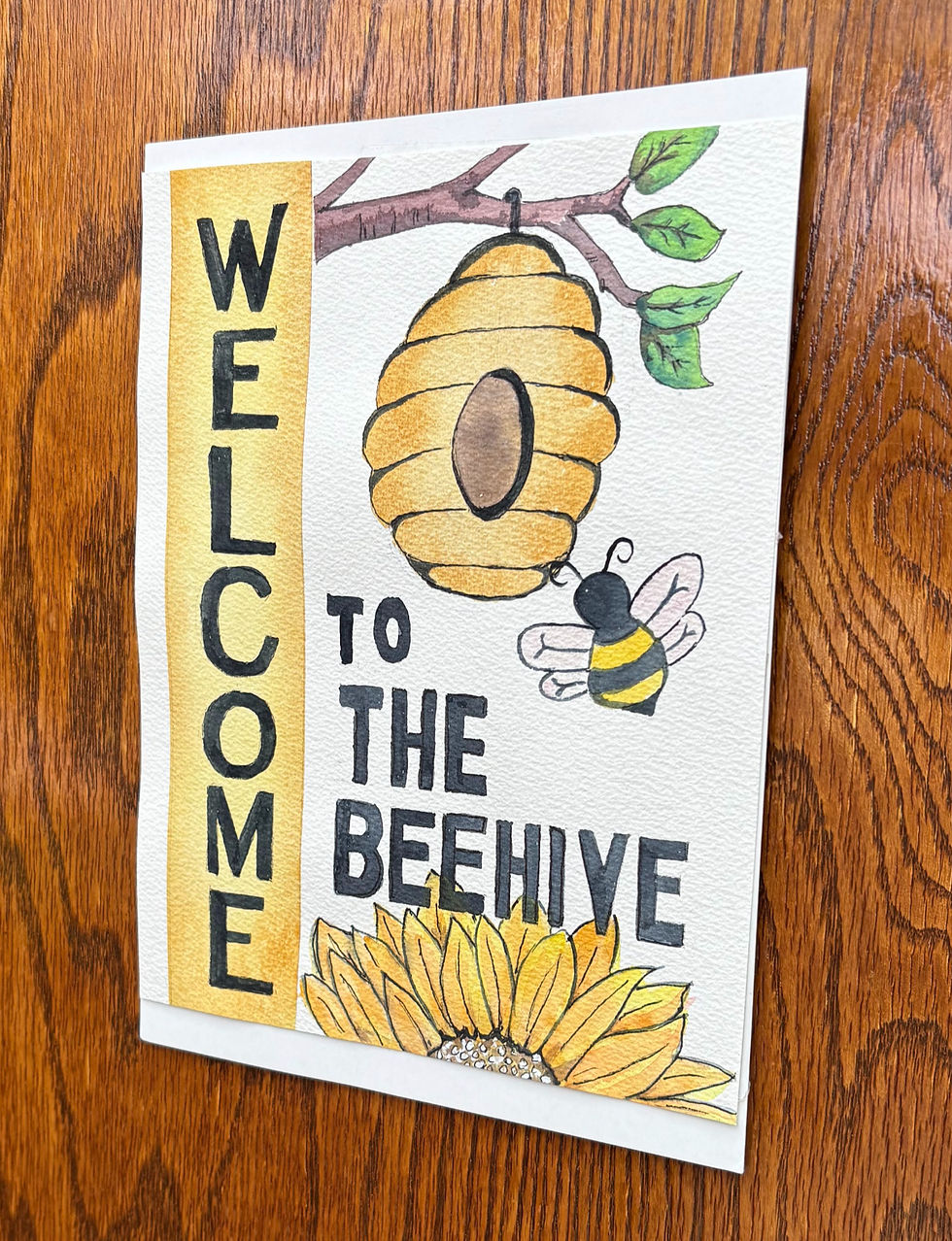 Welcome sign with a beehive, bee, and sunflower on wood background. Text: "WELCOME TO THE BEEHIVE" in black on yellow.