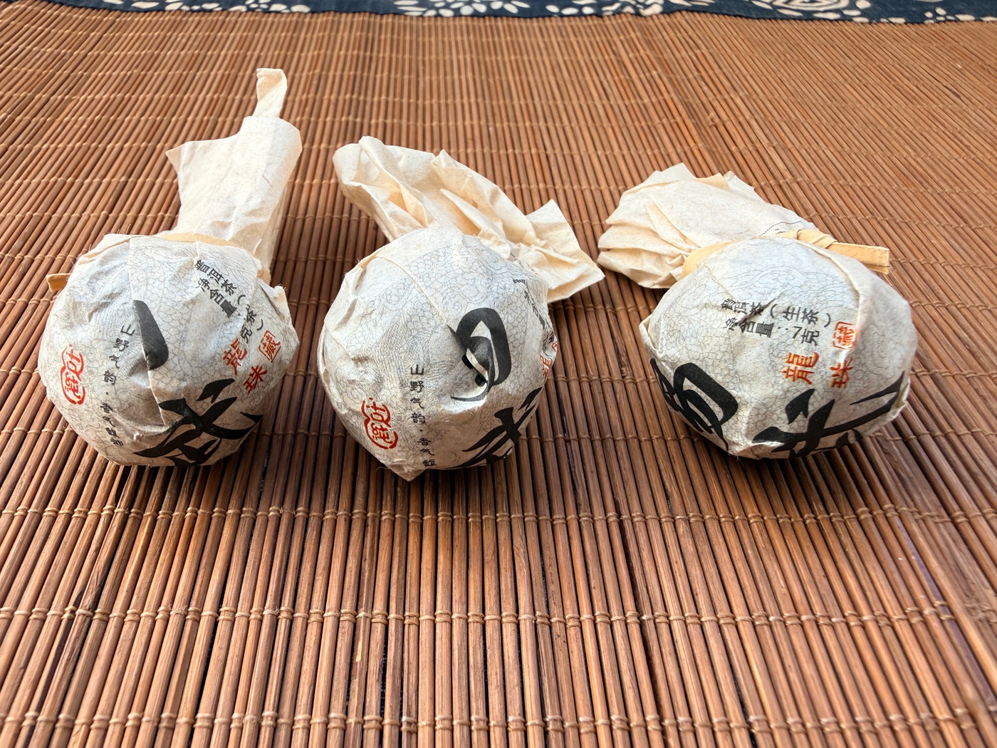 A singular hand-rolled Pu-erh tea ball from the legendary Bulang Mountain region.