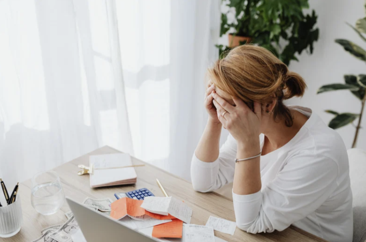 Woman doing taxes stressed