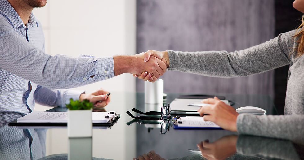 Two people shaking hands in agreement.