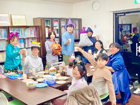Halloween fun at Japanese class: students celebrate with festive hats, delicious food, and mini-games, creating a joyful and lively atmosphere.