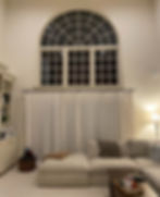 A large arch window in the living room