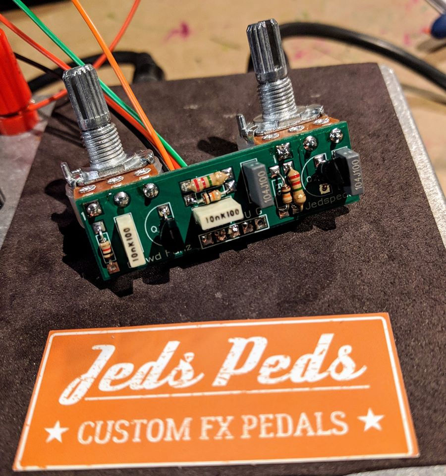 front view of completed guitar pedal circuit board with knob posts