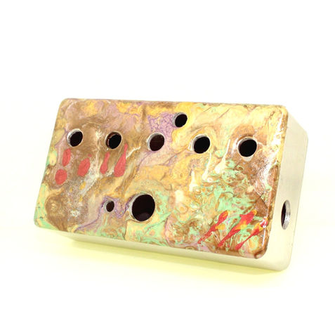 Splotched pattern with coloured accents on a drilled guitar effects pedal enclosure