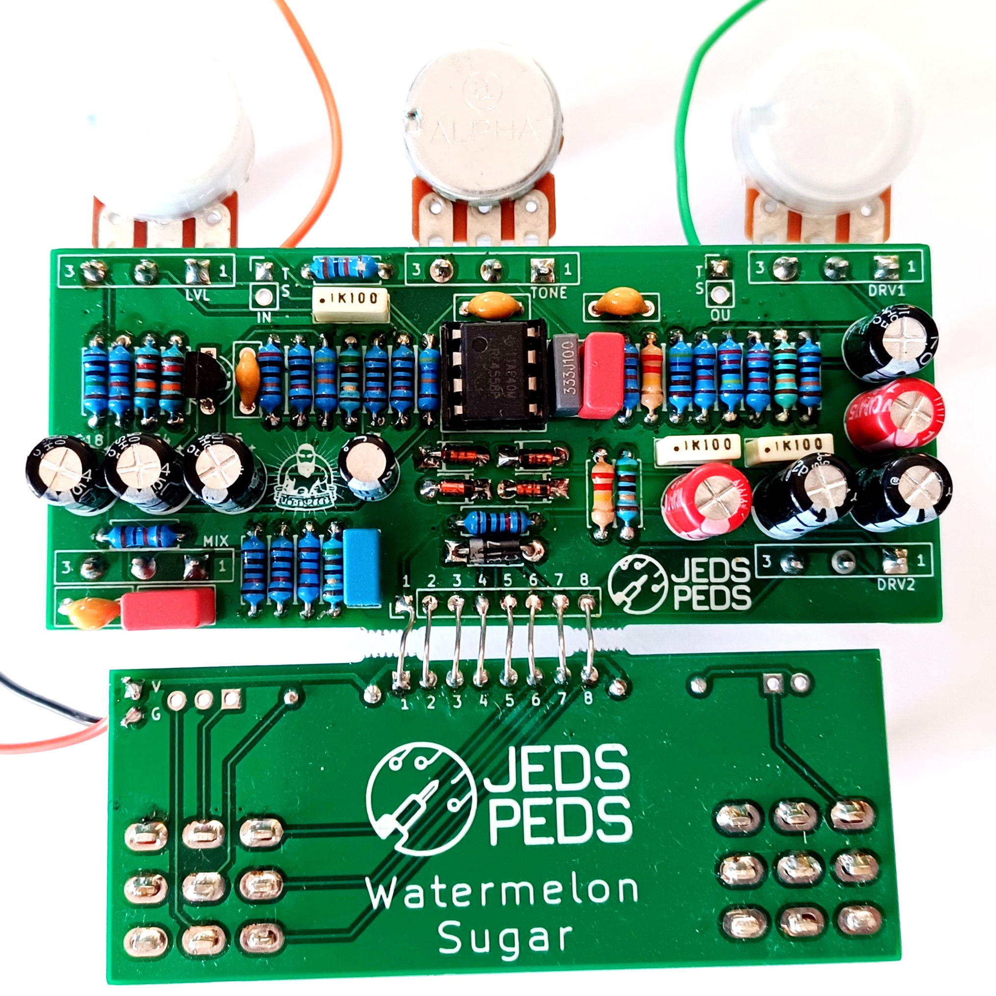 front view of 2 connected completed guitar pedal circuit boards