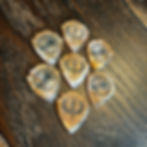 7 artfully arranged gold guitar picks