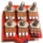 front view of completed guitar pedal circuit board with knob posts