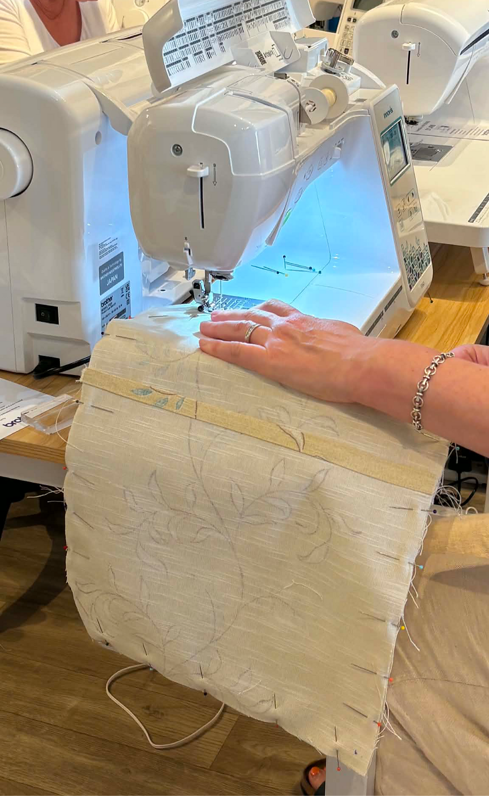 Hands on a sewing machine sewing a cushion cover in a sewing class in North Yorkshire
