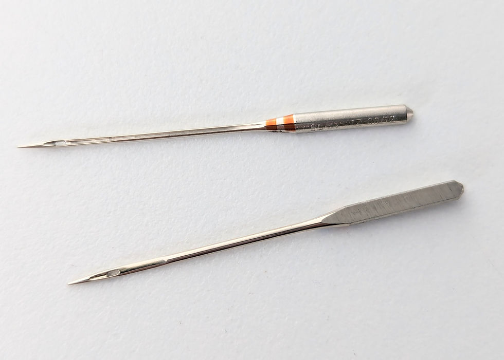 Two sewing machine needles on a white background