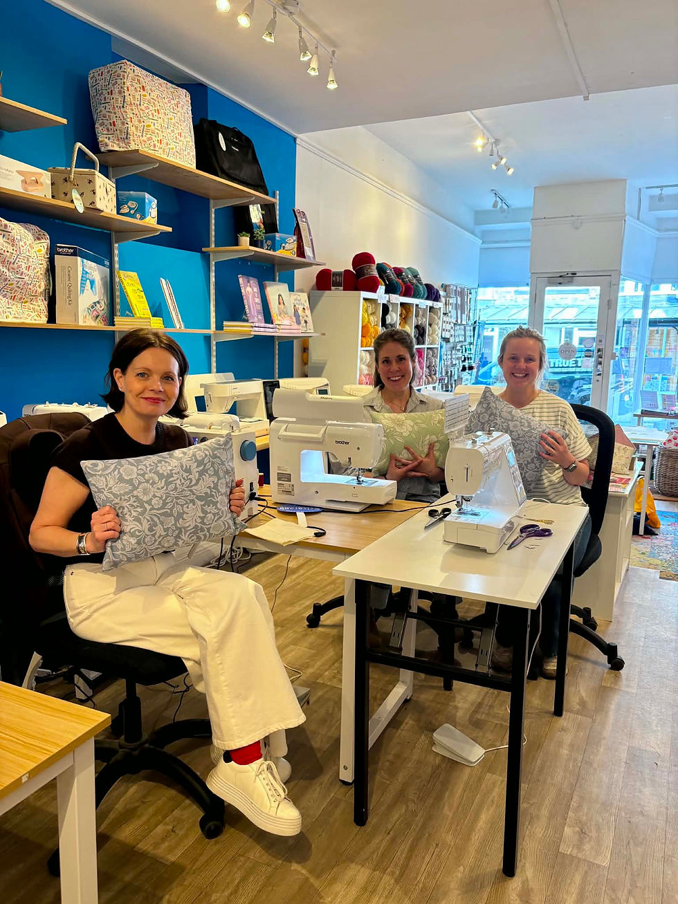 Three ladies showing the cushions they made in the sewing workshop for beginners in Harrogate
